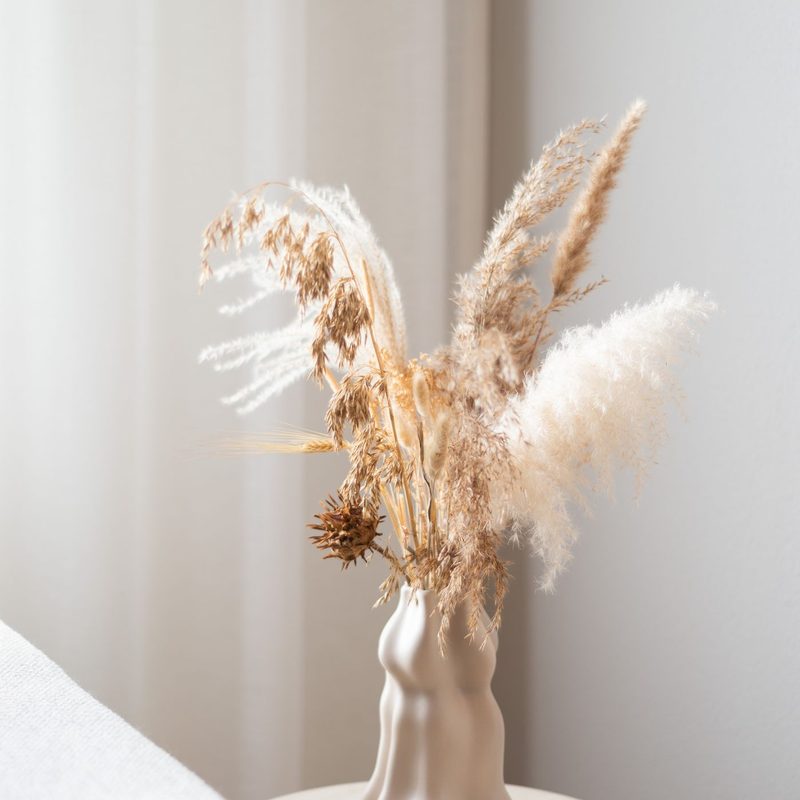 Dried flowers in a pale vase