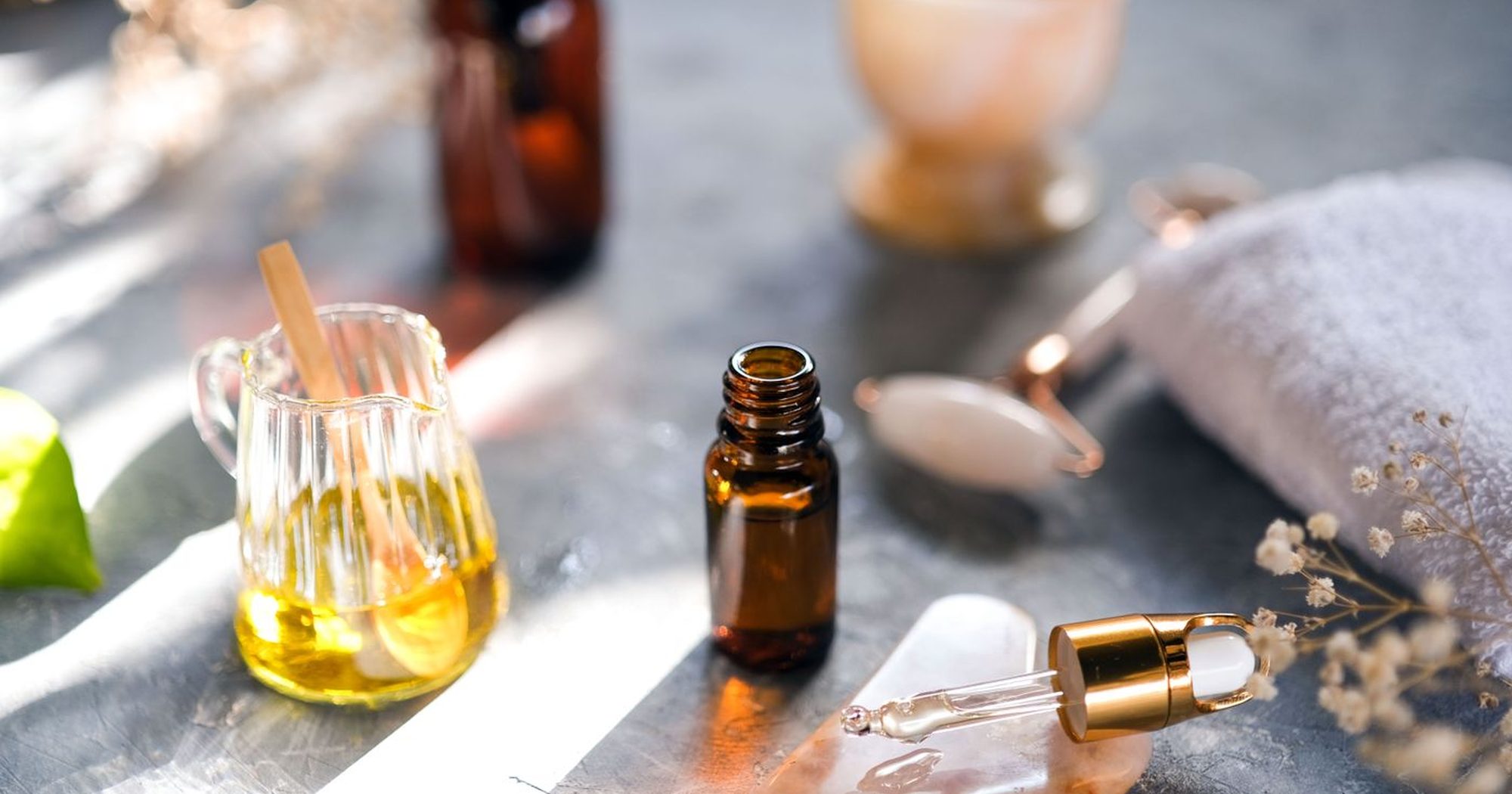 Amber bottles and oils in warm morning light